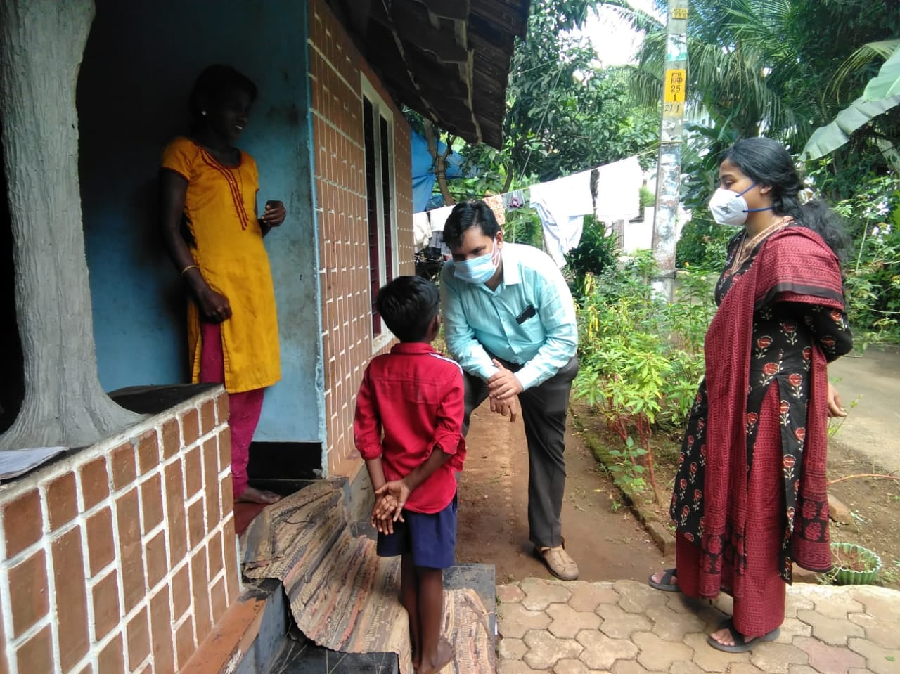 Dr. Rakesh PS engaging with families during a community health outreach visit